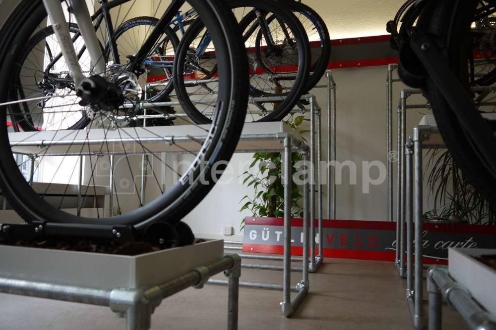 Bike display stands constructed using black powder-coated Interclamp key clamp fittings, featuring a robust and elegant design for showcasing bicycles.